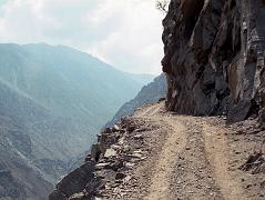 03 Dangerous Jeep Road Towards Fairy Meadows On the 15km jeep ride from the Rakhiot Bridge to Tato, I can look over the edge of the road on the way to Fairy Meadows at the sheer drop of 1000m and think about, well, death.  I especially feared if we would meet another jeep, but we didn't. I watch the local driver and hope he had a good night's sleep and is in a good mood. My life is clearly in his hands and feet. After a drive of one hour we arrived at the small village of Tato (2300m).